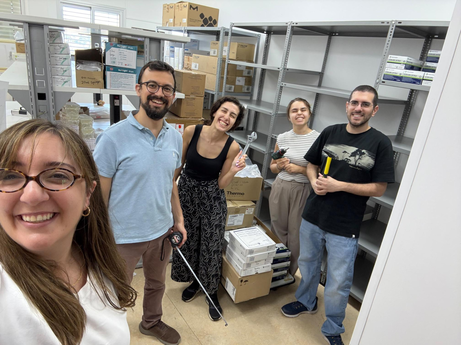 CMIT team members together in the laboratory storeroom